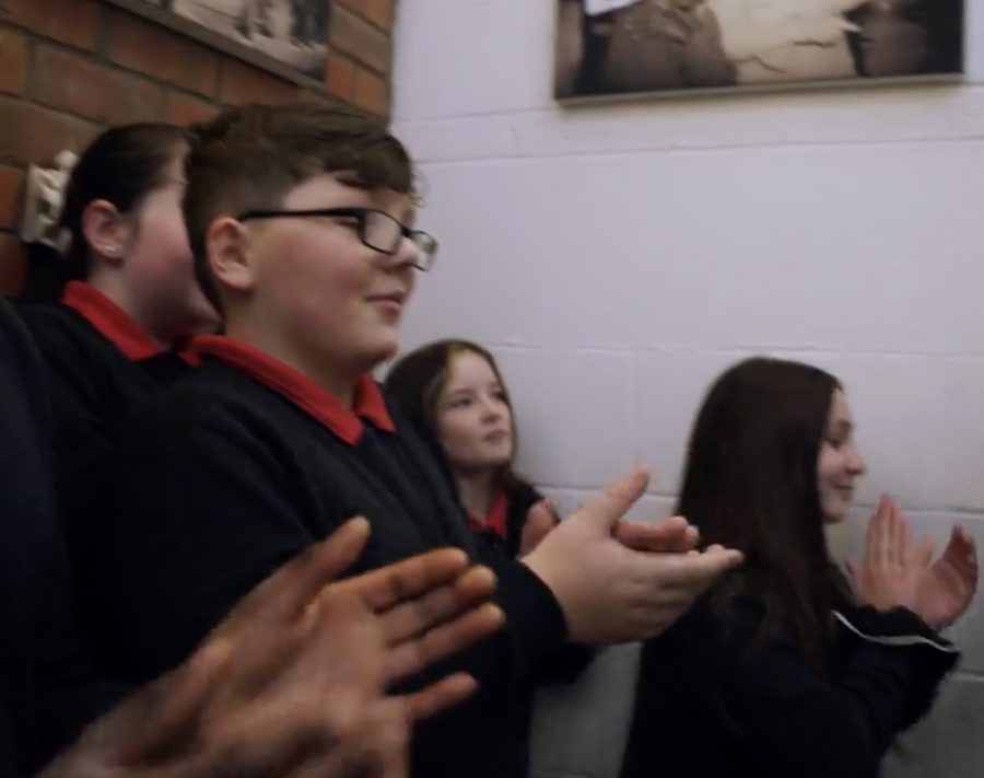 Pupils clapping together at an assembly